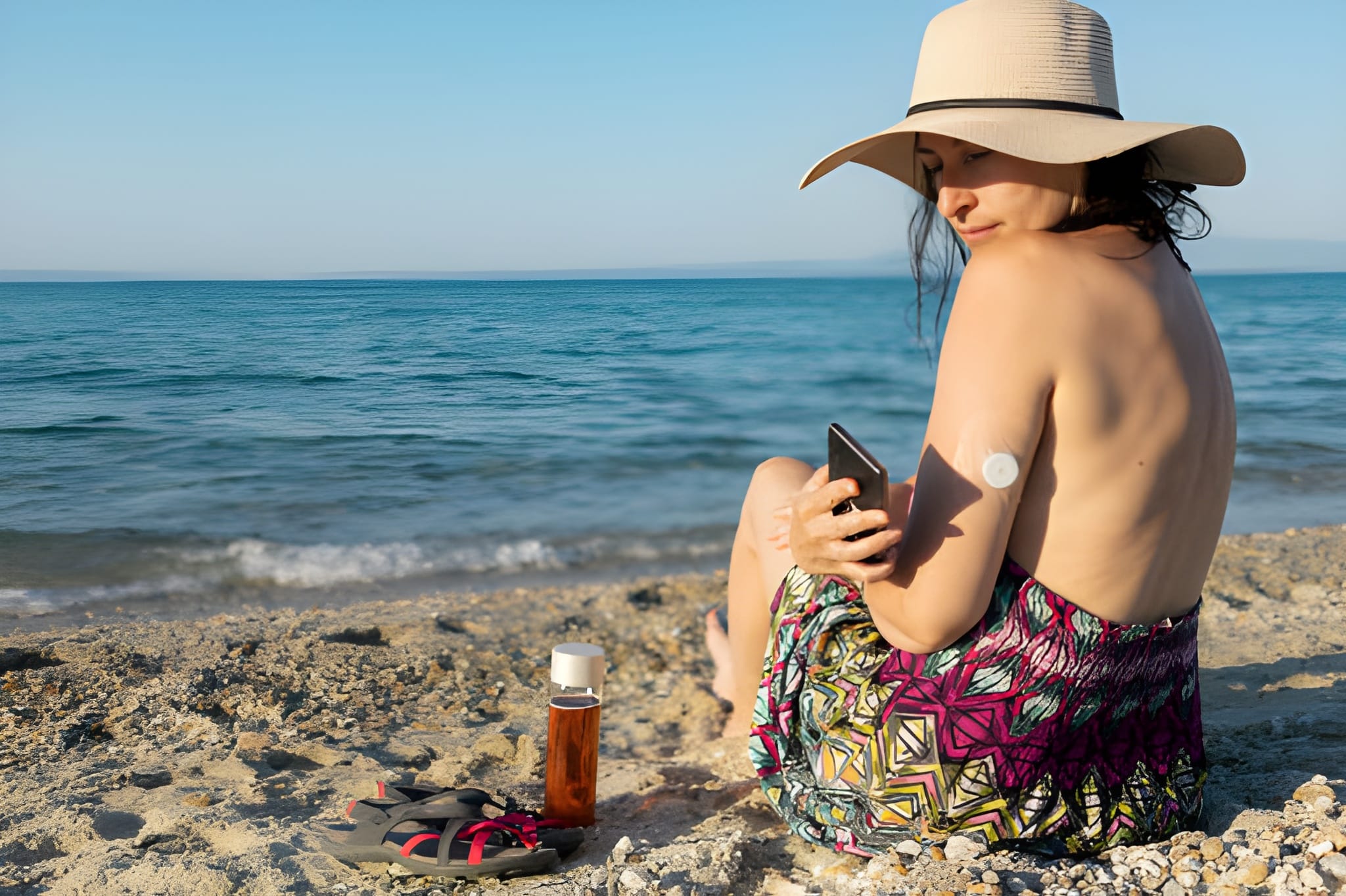 lady with a hat is enjoying her weekend at the beach at sunset
