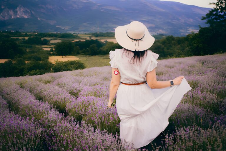 woman in white dress and straw hat enjoying in lavender field moments of happiness