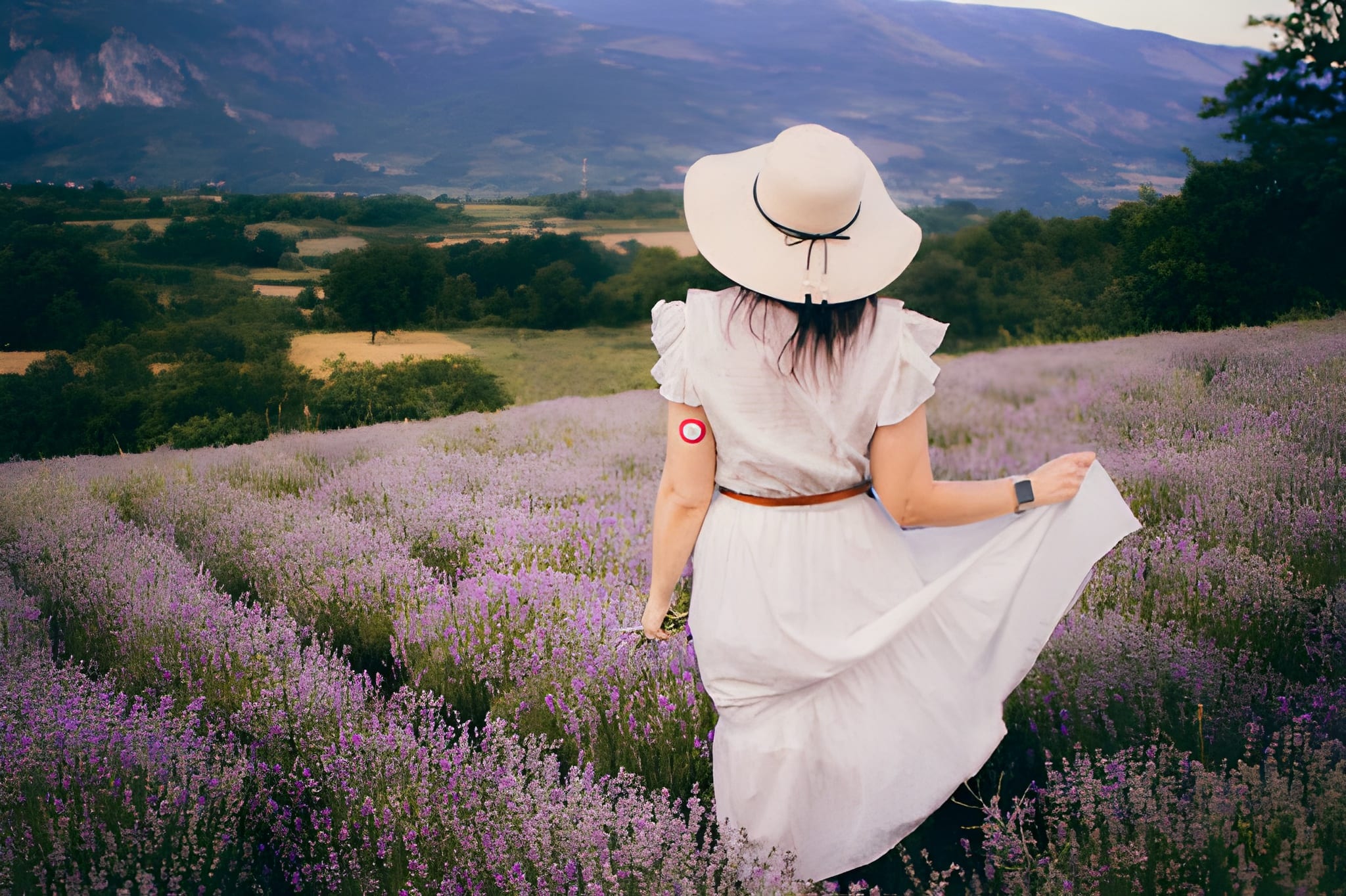 woman in white dress and straw hat enjoying in lavender field moments of happiness